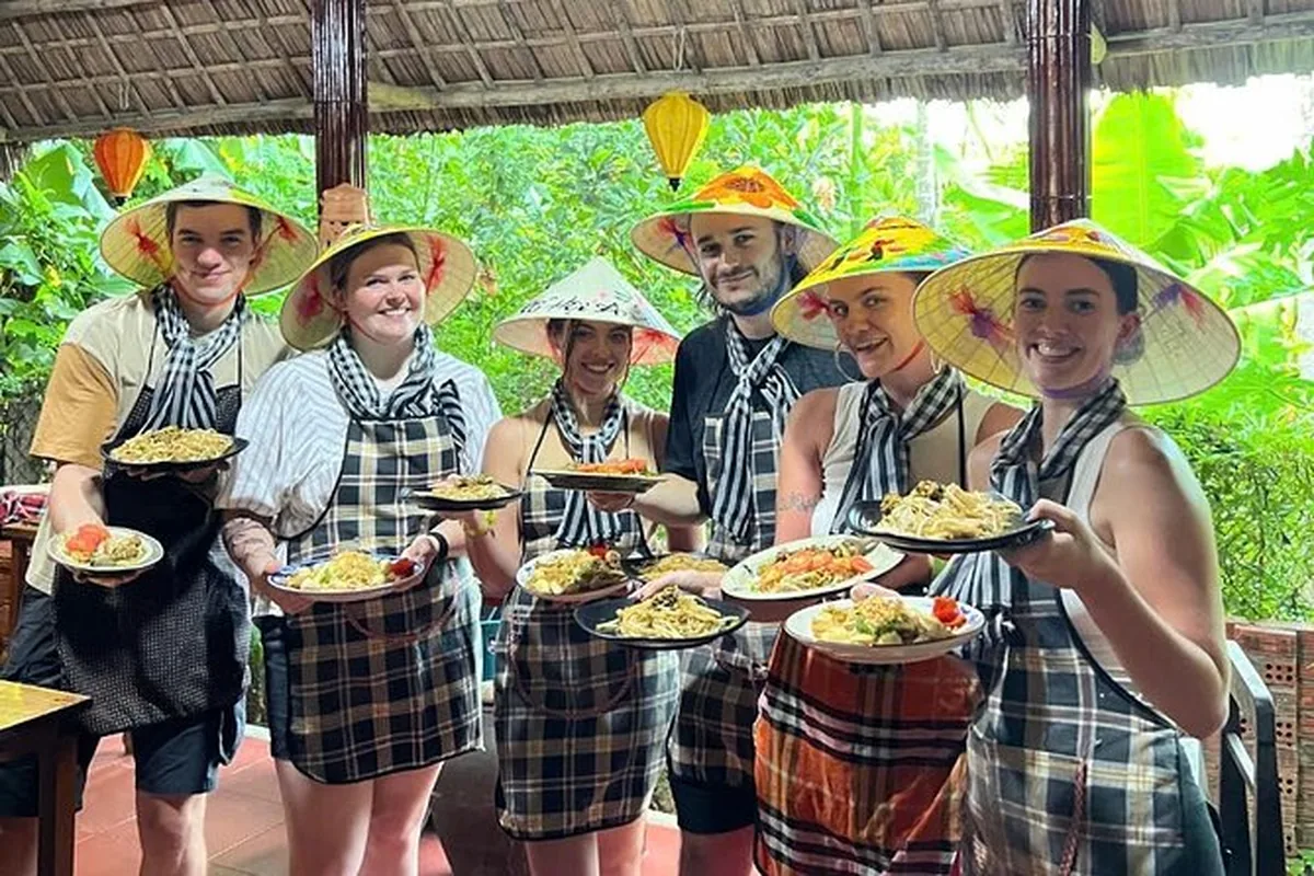 Travelers preparing Vietnamese dishes during a Hoi An cooking class